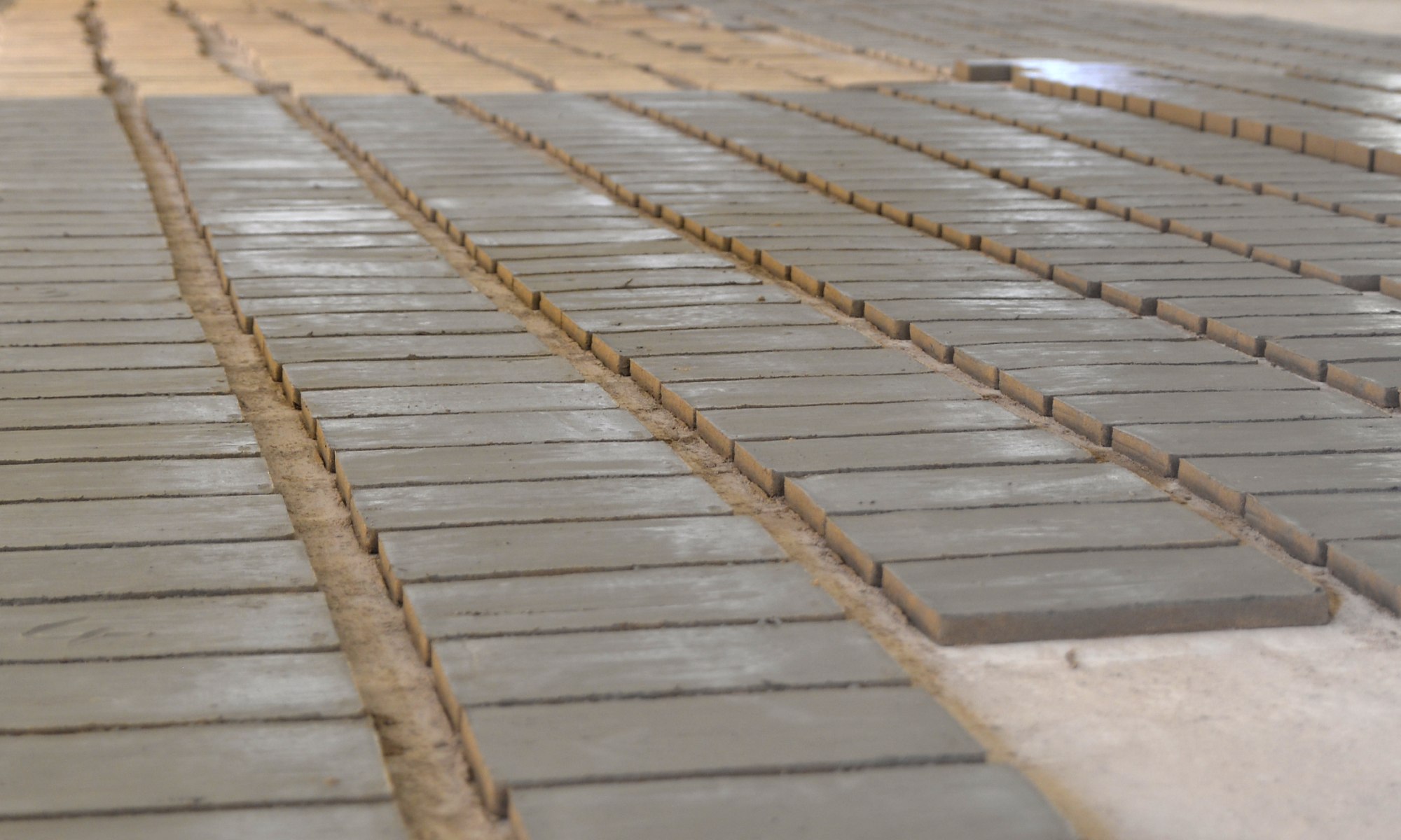 Laying of handmade bricks on the ground after shaping
